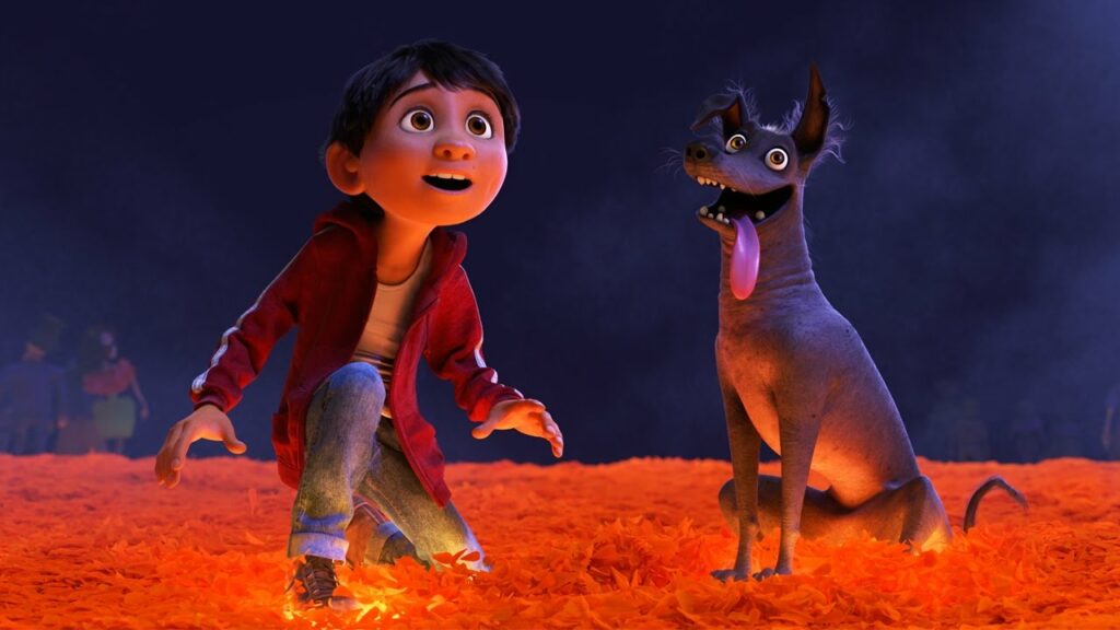 Die besten animierten Filme für die ganze Familie: Auf dem Bild ist ein Junge und ein Hund abgebildet. Der Hund hat einen irren Blick und lässt die Zunge raus hängen. Der Junge schaut begeistert in die Ferne und stützt sich mit einem Knie am Boden ab