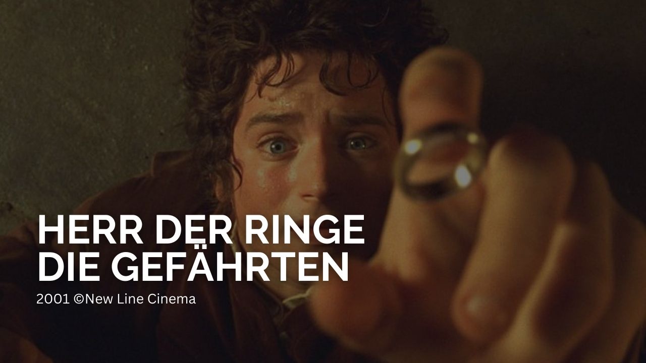 Herr der Ringe die Gefährten: Das Bild zeigt Frodo, der auf dem Boden liegt und den Ring auffängt