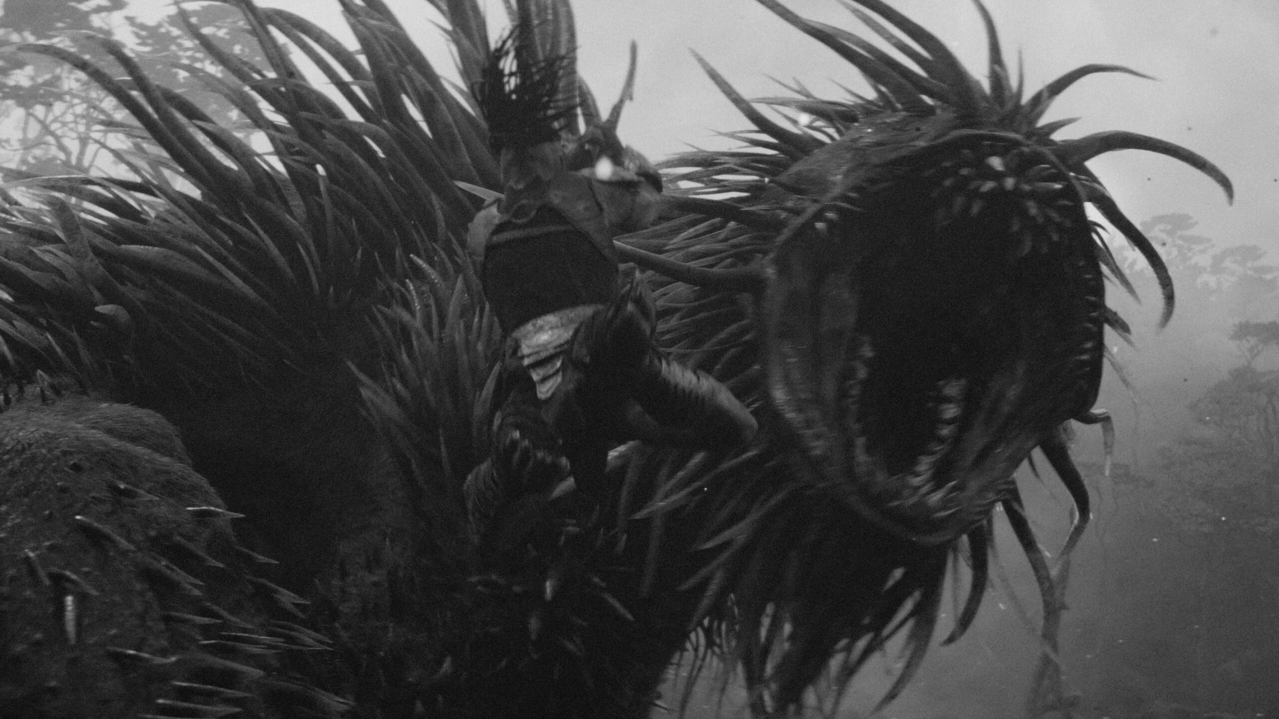 Eine monströse Gestalt reißt ihr Maul auf, während Dek auf sie zu springt