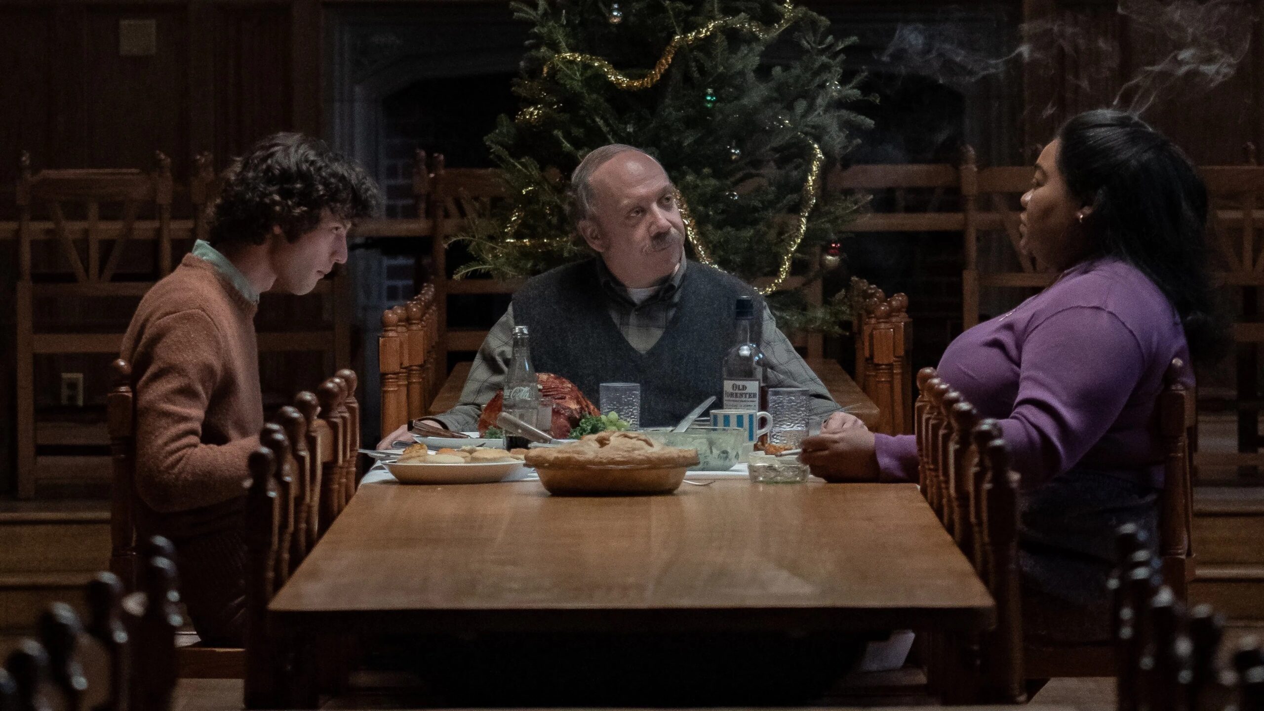 Paul Giamati, Dominic Sessa und Da'Vine Randolph im Film "The Holdovers" sitzen an einem Tisch mit Essen, im Hintergrund ist ein Weihnachtsbaum | Die 5 besten Familienfilme für die Feiertage