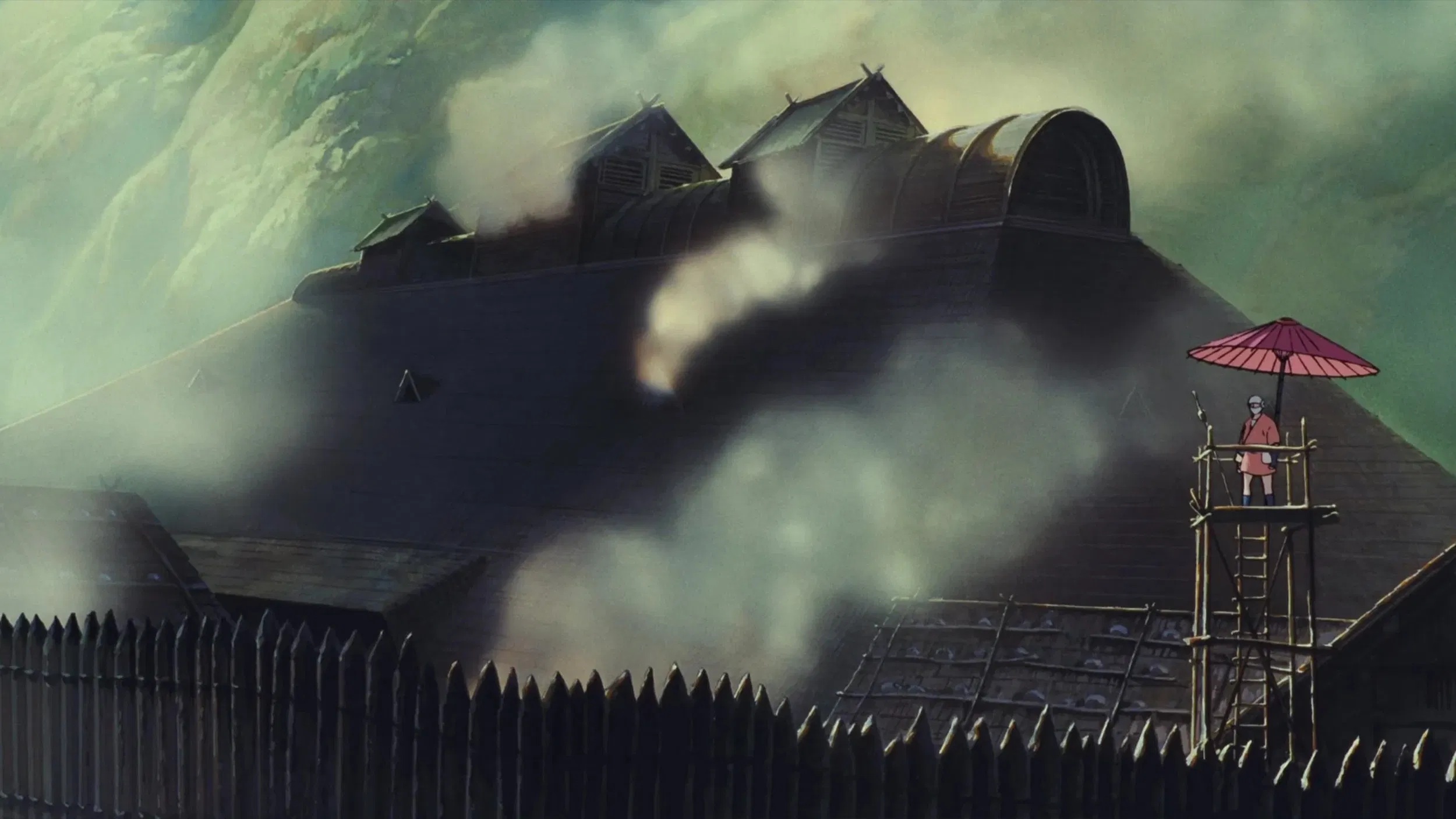 Die Eisenhütte, ein großes Gebäude, von Nebel und Dampf umgeben